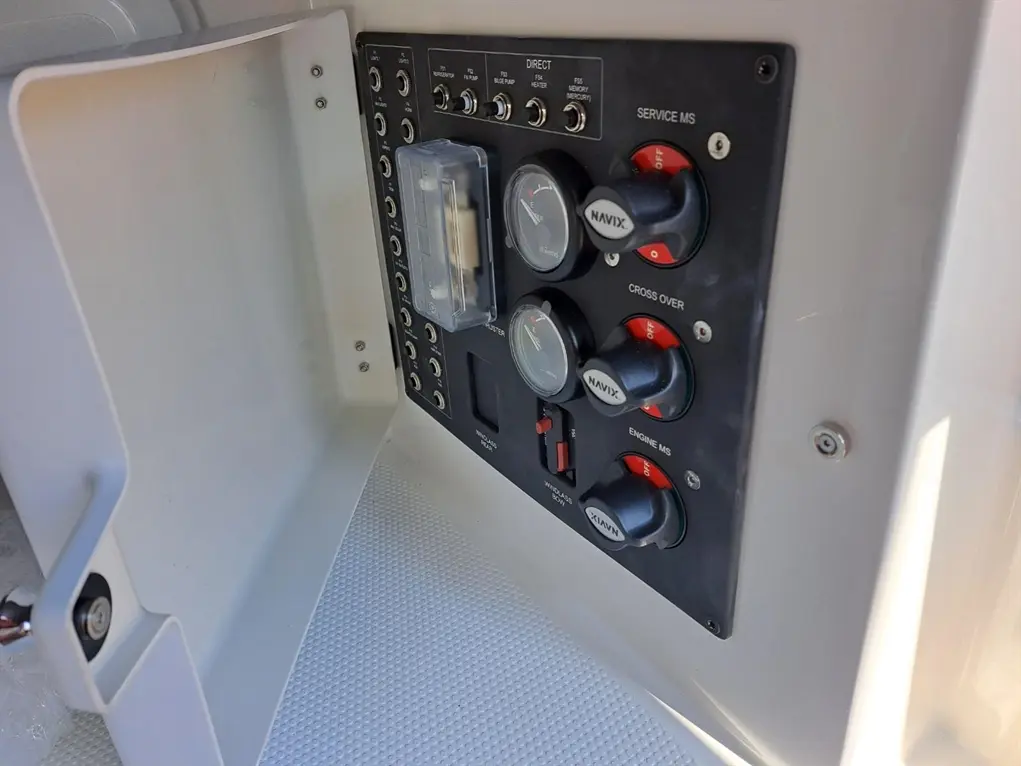 Control panel features gauges and switches labeled 'NAVIX', 'SERVICE MS', and 'CROSS OVER' in a marine environment.